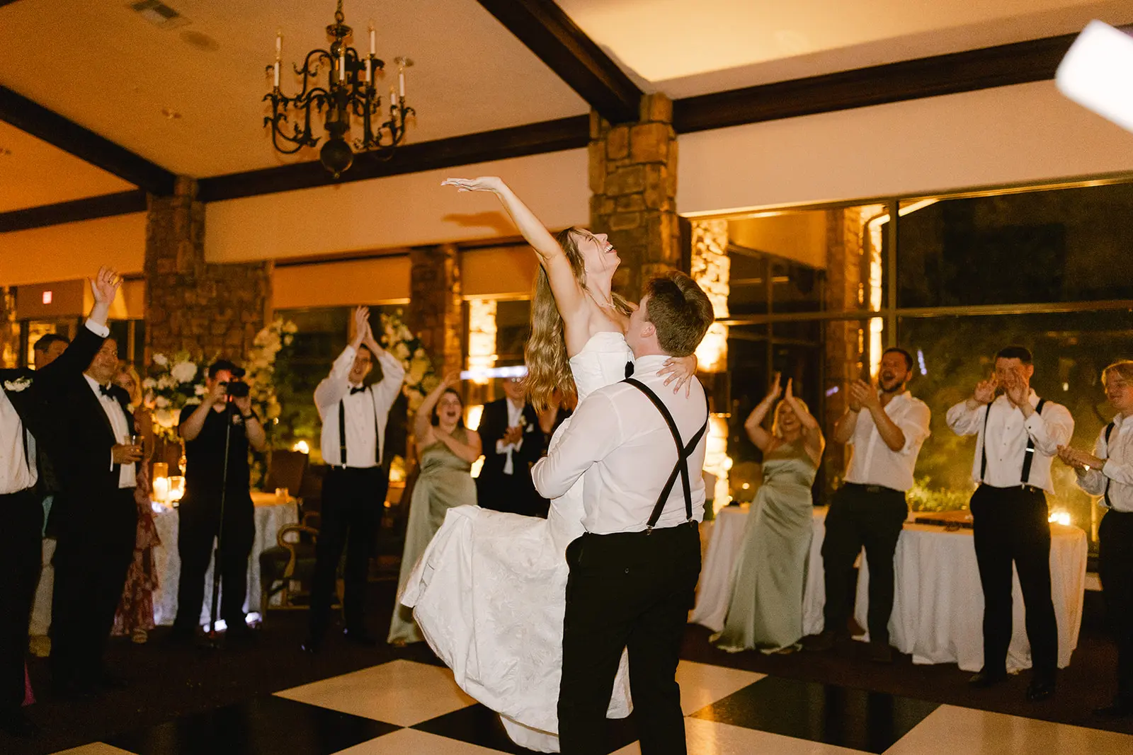 Newlyweds celebrating on the dance floor with their wedding party